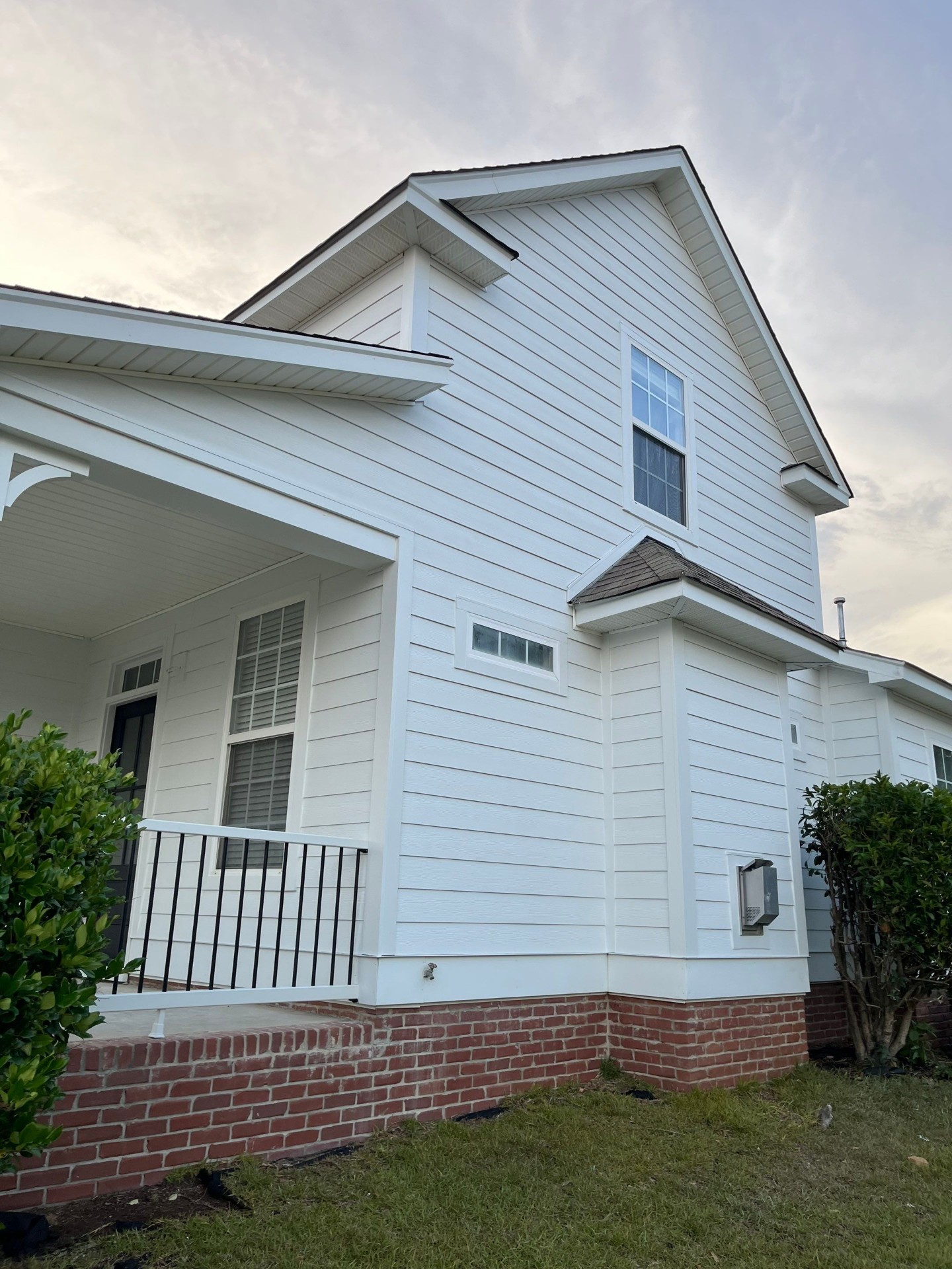 White siding and soffit installation on a two-story home